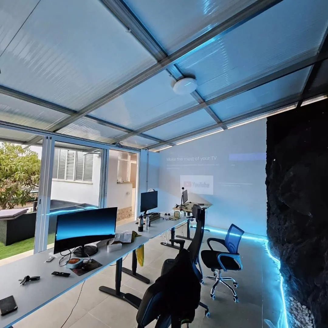Coworking room with monitors and volcanic rock texture.