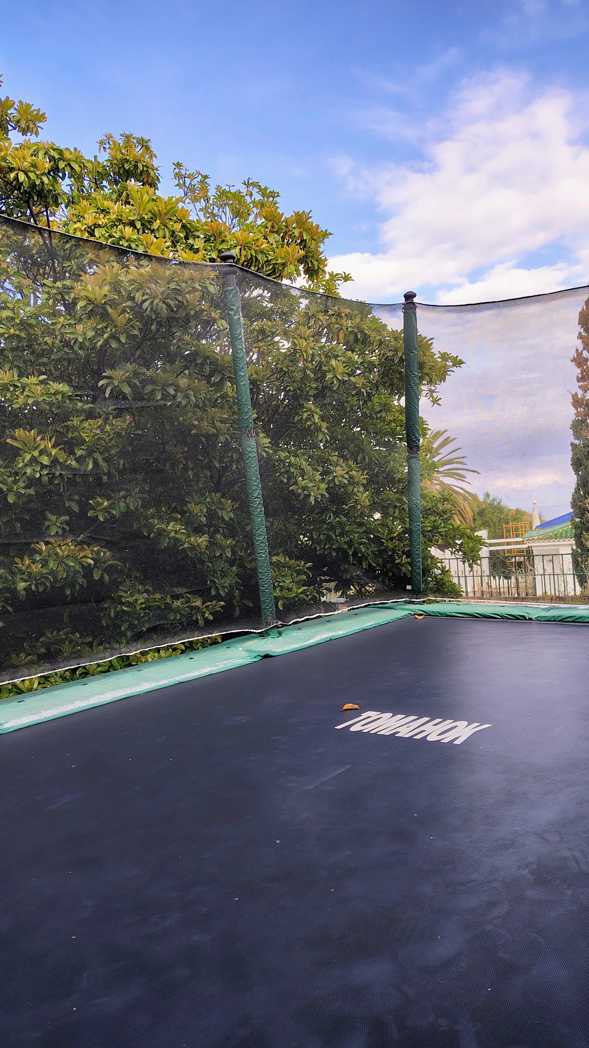 Outdoor terrace area with fitness equipment and trampoline space.