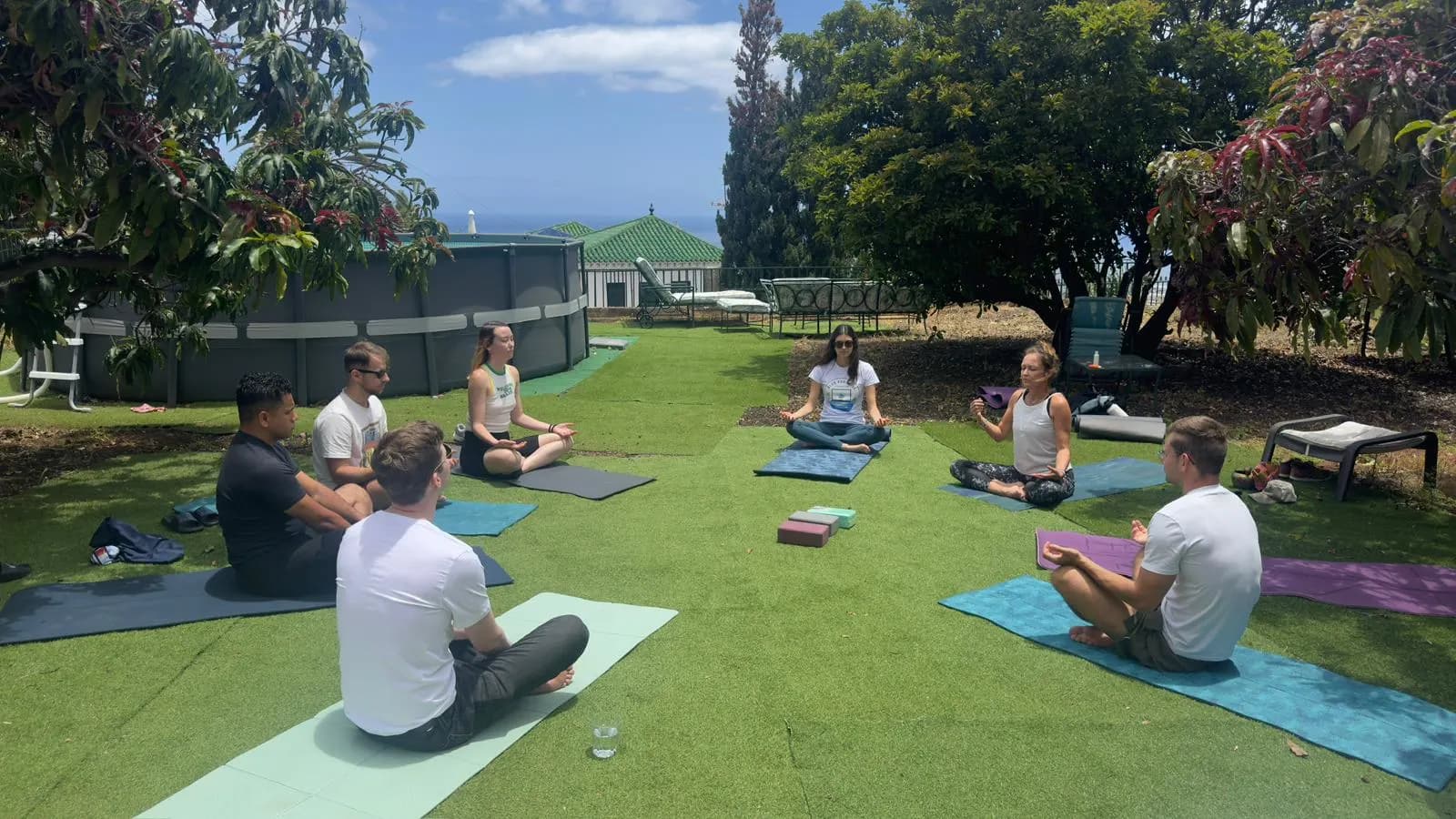 Blue Paradise colivers doing an outdoor wellness session in the garden.